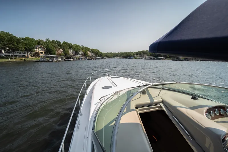 Slide: The Image of 2007 Sea Ray 340 Sundancer cruising on a scenic lake with waterfront homes. - 29