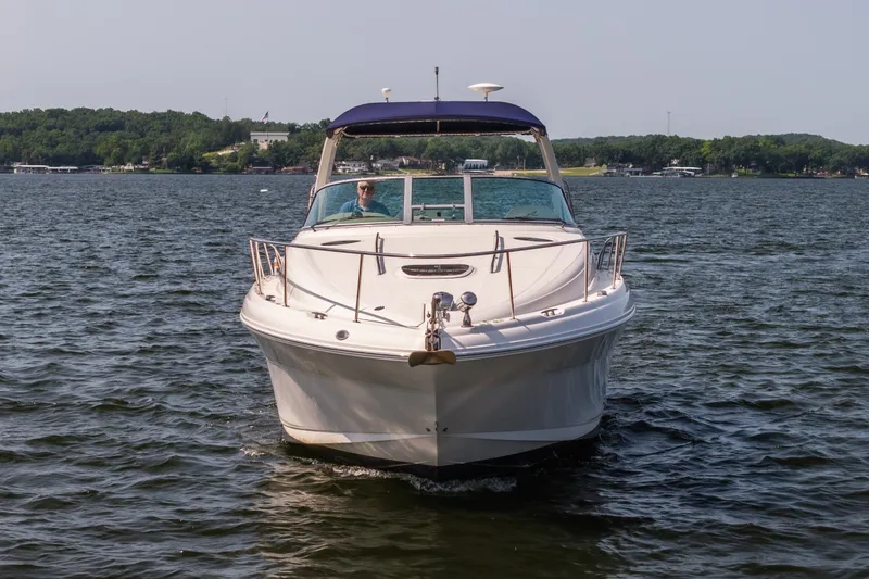 Slide: The Image of 2007 Sea Ray 340 Sundancer cruising on a lake with lush green shoreline. - 5