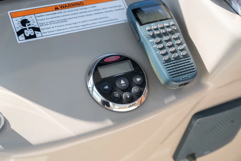 Slide: The Image of Control panel of a 2007 Sea Ray 340 Sundancer with radio and warning label. - 48