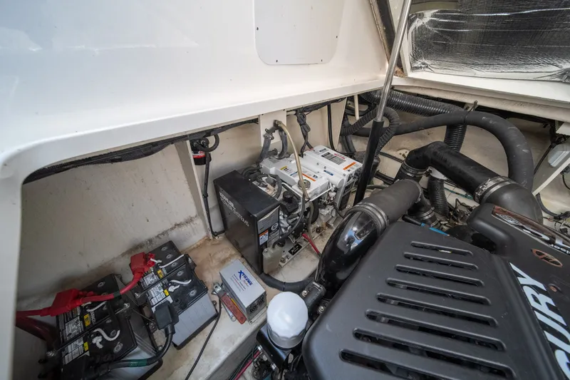 Slide: The Image of Engine compartment of 2007 Sea Ray 340 Sundancer with batteries and mechanical components. - 25