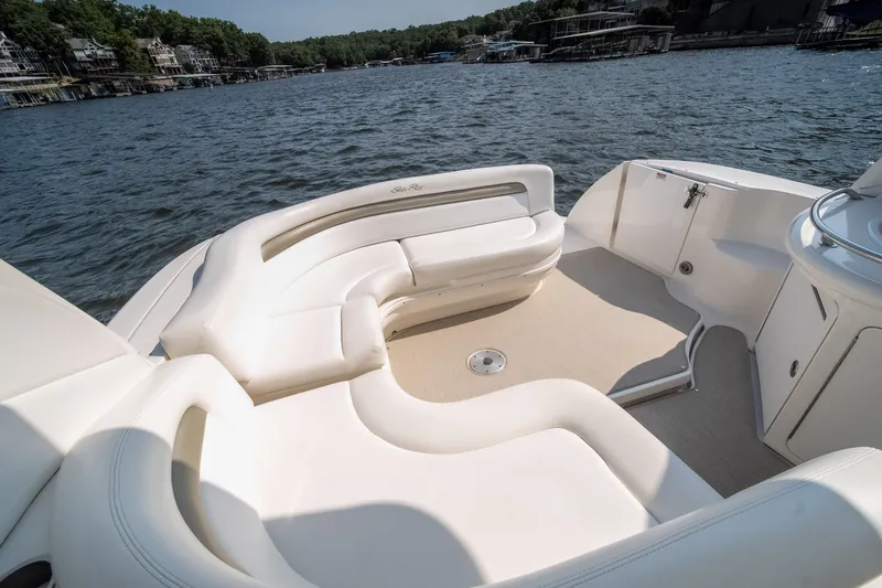 Slide: The Image of 2007 Sea Ray 340 Sundancer boat interior with white seating on a sunny day. - 22