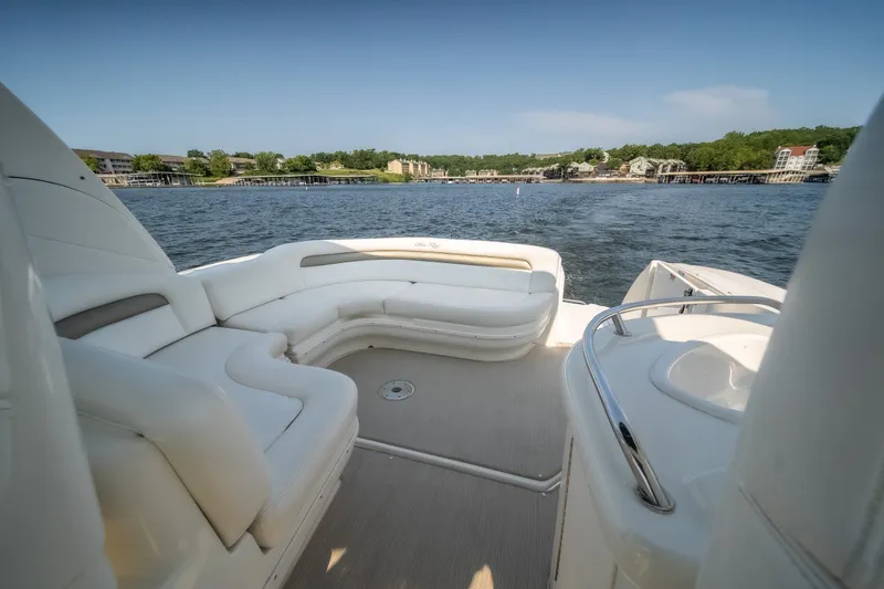 Slide: The Image of 2007 Sea Ray 340 Sundancer boat interior with white seating, overlooking serene waters. - 11