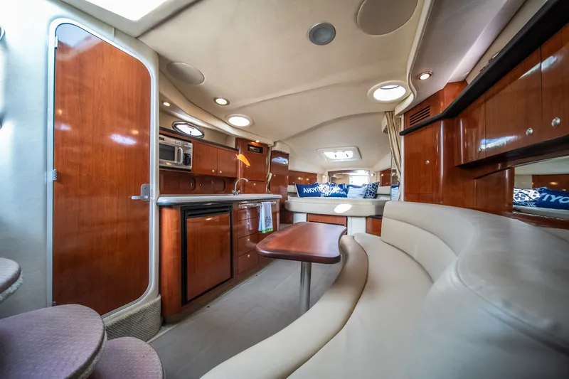 Slide: The Image of Luxurious interior of 2007 Sea Ray 340 Sundancer yacht with wood cabinetry and plush seating. - 57