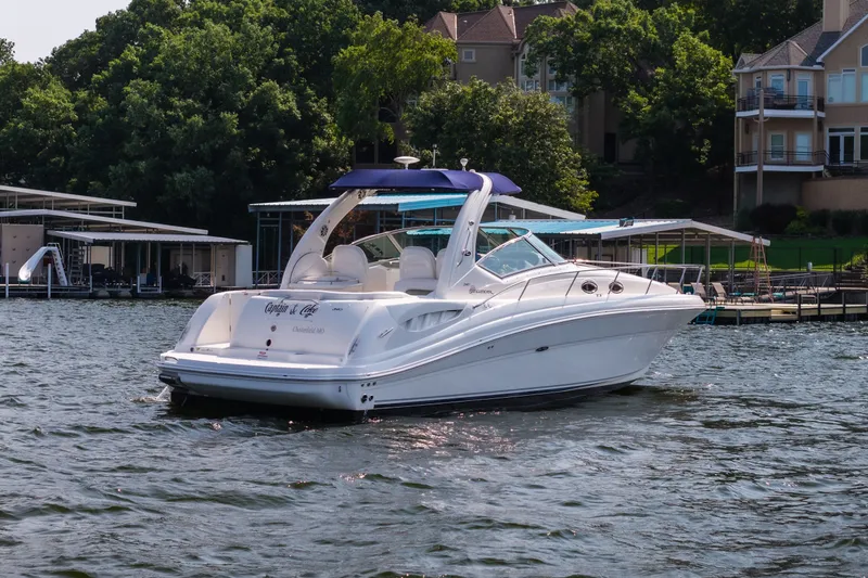Slide: The Image of 2007 Sea Ray 340 Sundancer yacht on a scenic lake with waterfront homes. - 1