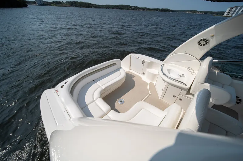 Slide: The Image of 2007 Sea Ray 340 Sundancer boat interior with white seating on a calm lake. - 35