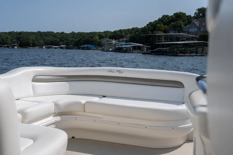 Slide: The Image of 2007 Sea Ray 340 Sundancer boat interior with white seating on a lake. - 44