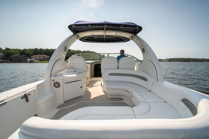 Slide: The Image of 2007 Sea Ray 340 Sundancer boat with spacious seating on a serene lake. - 12