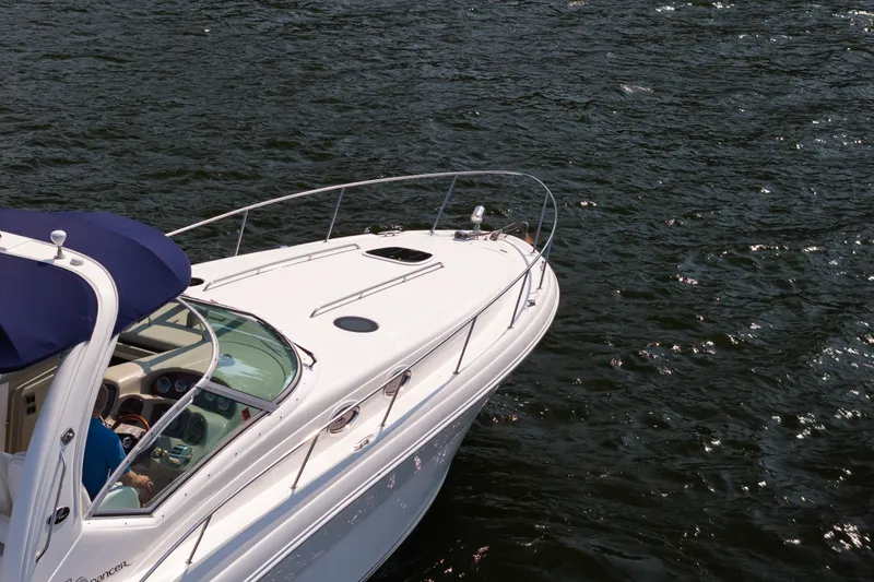 Slide: The Image of 2007 Sea Ray 340 Sundancer cruising on open water, showcasing sleek design and luxury features. - 2