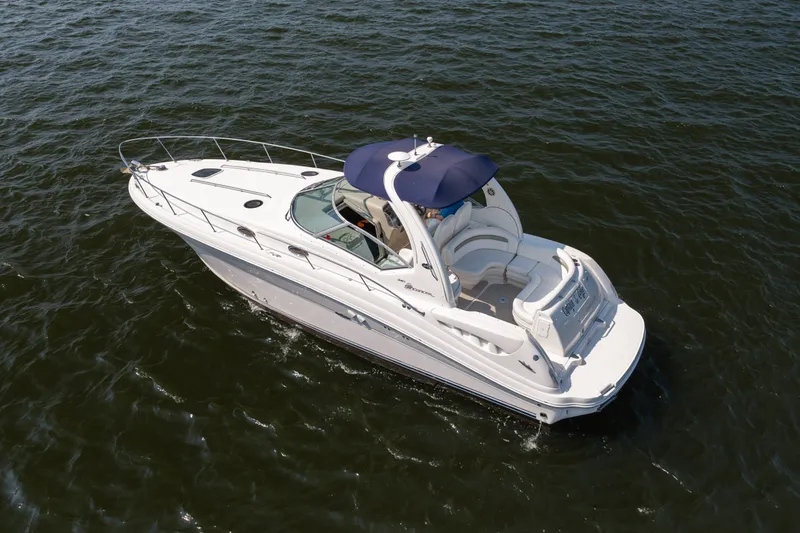 Slide: The Image of 2007 Sea Ray 340 Sundancer cruising on open water, featuring sleek design and spacious deck. - 7