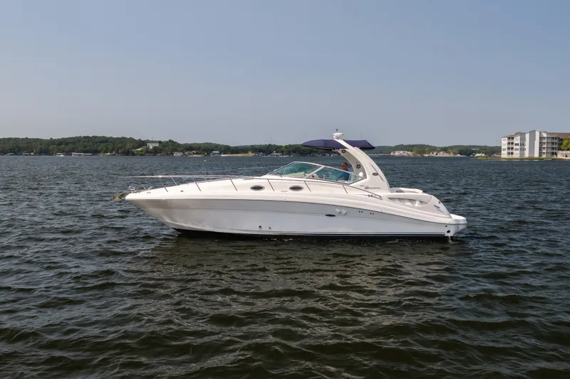 The Image of 2007 Sea Ray 340 Sundancer yacht cruising on a calm lake under clear skies. - 0