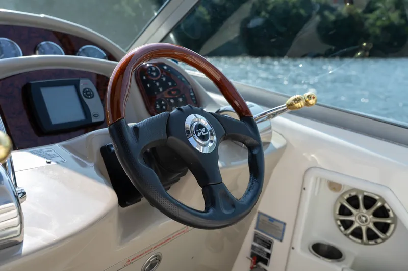 Slide: The Image of Steering wheel of 2007 Sea Ray 340 Sundancer boat with dashboard controls. - 40