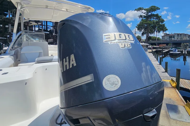 Slide: The Image of Edgewater 245CX Crossover 2013 with Yamaha 300 V6 engine at a marina dock. - 7