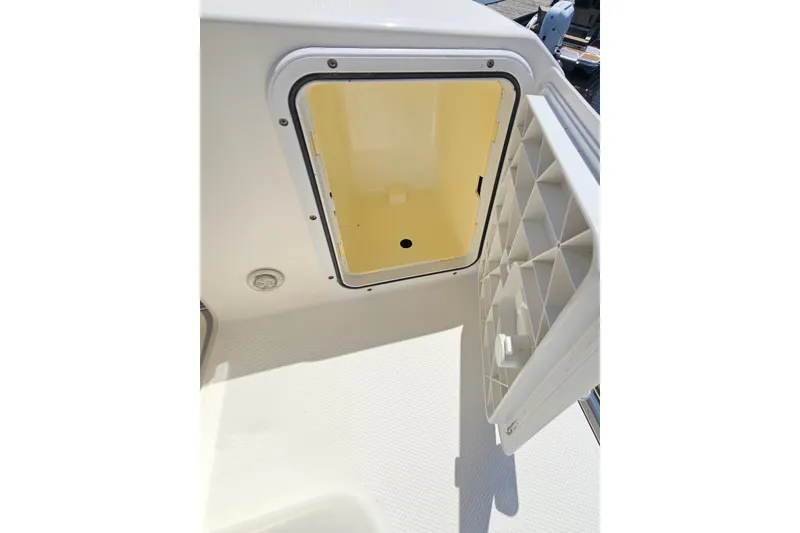 Slide: The Image of Open storage compartment on 2013 Edgewater 245CX Crossover boat. - 27