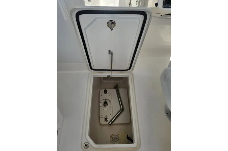 Slide: The Image of Open storage compartment on 2013 Edgewater 245CX Crossover boat. - 28