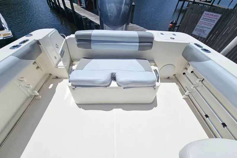 Slide: The Image of 2013 Edgewater 245CX Crossover boat interior with cushioned seating and storage. - 8