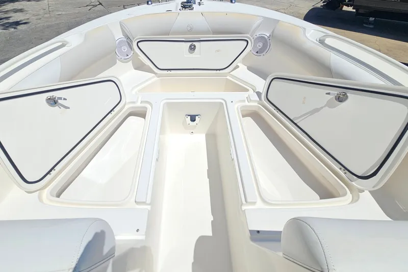 Slide: The Image of 2013 Edgewater 245CX Crossover boat interior with open storage compartments. - 24