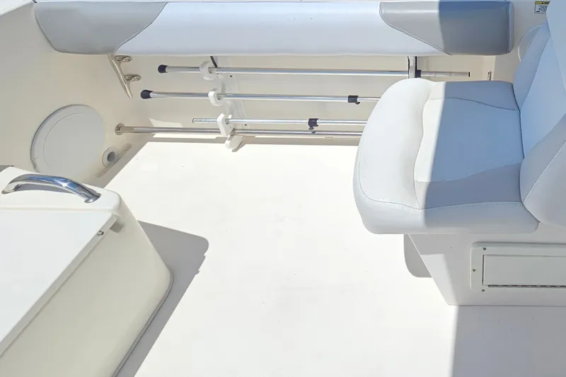 Slide: The Image of Interior seating of a 2013 Edgewater 245CX Crossover boat with rod holders. - 14