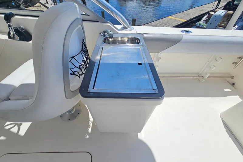 Slide: The Image of Interior of 2013 Edgewater 245CX Crossover boat with sink and seating area. - 11
