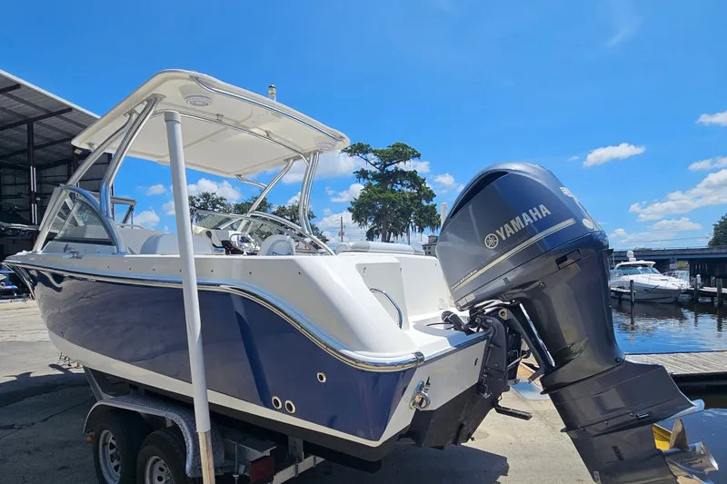Slide: The Image of 2013 Edgewater 245CX Crossover boat with Yamaha engine at marina dock. - 4