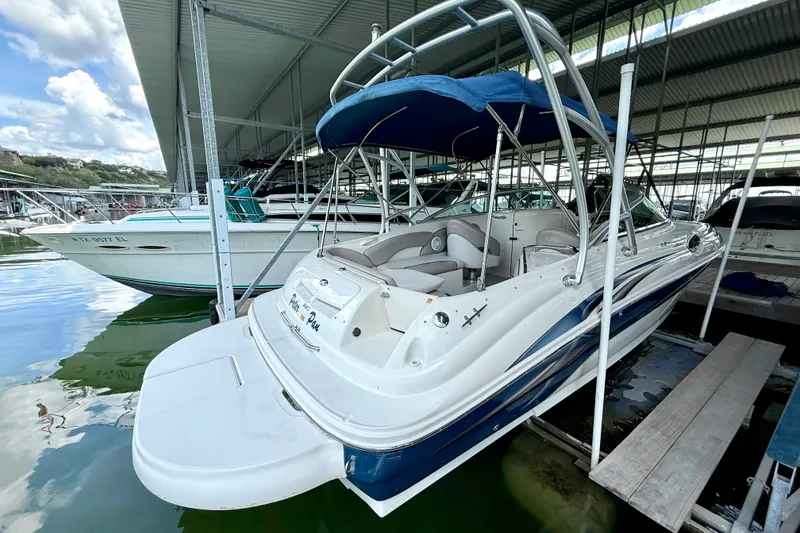 Slide: The Image of 2003 Sea Ray 240 Sundeck boat docked under a covered marina. - 15