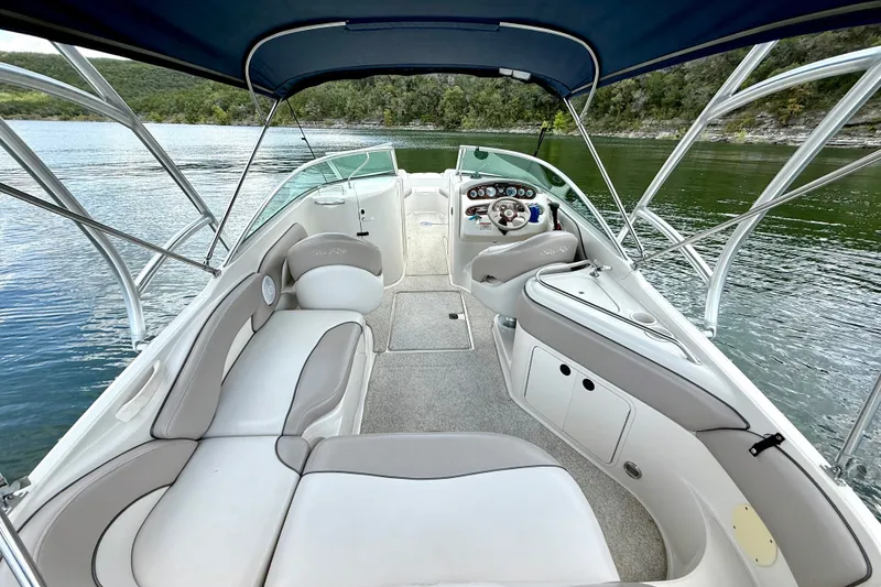 Slide: The Image of Interior view of a 2003 Sea Ray 240 Sundeck boat with seating and steering wheel. - 17