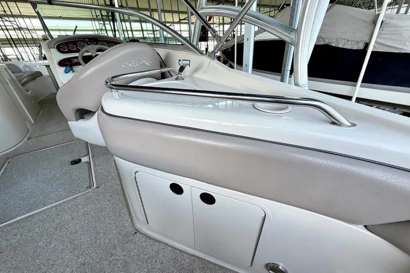 Slide: The Image of 2003 Sea Ray 240 Sundeck interior with steering wheel and dashboard controls. - 24