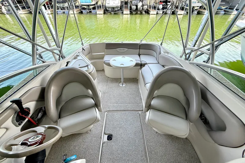 Slide: The Image of Interior of a 2003 Sea Ray 240 Sundeck boat with seating and steering wheel. - 22