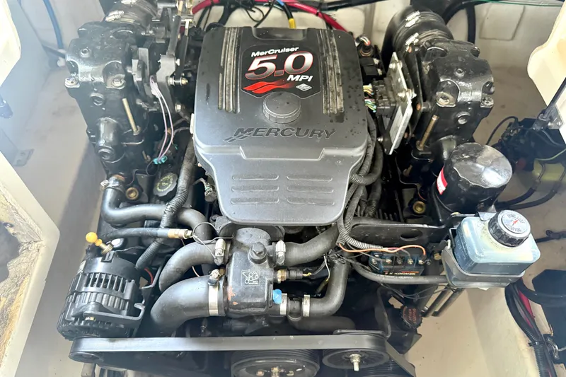 Slide: The Image of Engine of a 2003 Sea Ray 240 Sundeck boat, featuring a MerCruiser 5.0 MPI. - 32