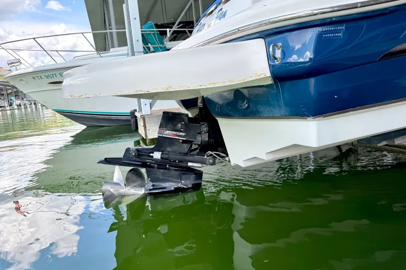 Slide: The Image of 2003 Sea Ray 240 Sundeck boat with Mercury outboard motor in marina. - 11