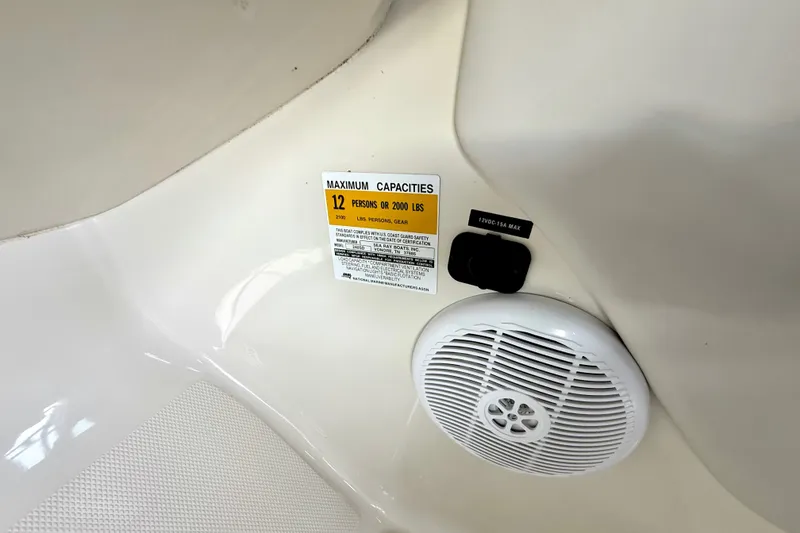 Slide: The Image of 2003 Sea Ray 240 Sundeck capacity label and speaker detail. - 30