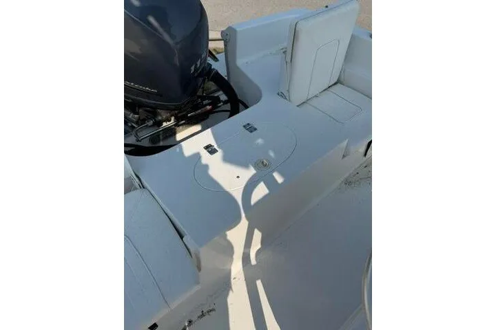 Slide: The Image of 2012 Sea Hunt Triton 177 boat interior with seating and motor detail. - 16