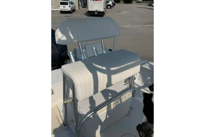 Slide: The Image of 2012 Sea Hunt Triton 177 boat seat with white upholstery and metal frame. - 14