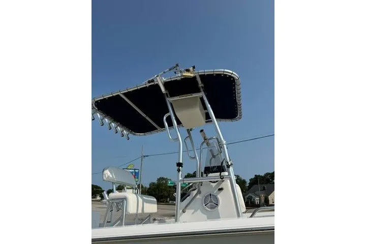 Slide: The Image of 2012 Sea Hunt Triton 177 boat with T-top and seating, under clear blue sky. - 9