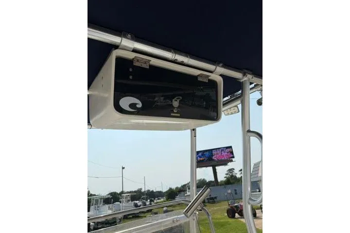 Slide: The Image of 2012 Sea Hunt Triton 177 boat with overhead console and outdoor background. - 19