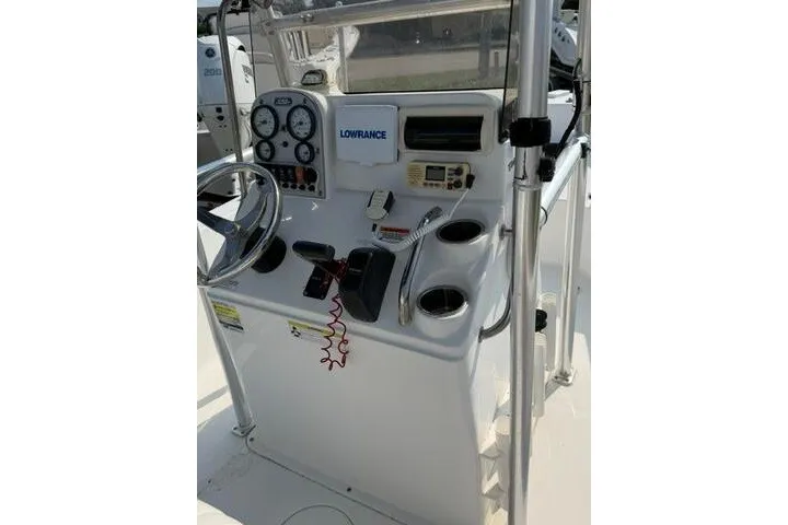 Slide: The Image of 2012 Sea Hunt Triton 177 boat console with steering wheel, gauges, and electronics. - 17