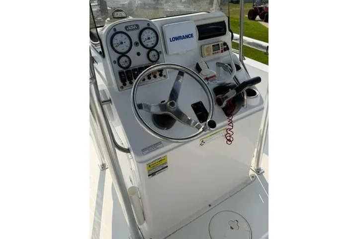 Slide: The Image of 2012 Sea Hunt Triton 177 boat console with steering wheel and navigation instruments. - 18