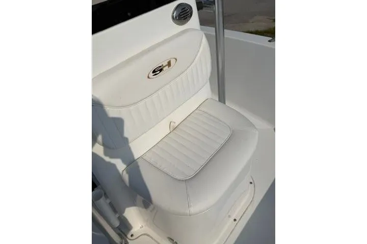 Slide: The Image of White cushioned seat on 2012 Sea Hunt Triton 177 boat, featuring SH logo. - 13