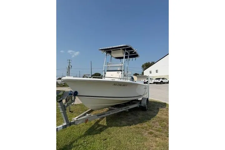 Slide: The Image of 2012 Sea Hunt Triton 177 boat on trailer, parked outdoors under clear sky. - 3