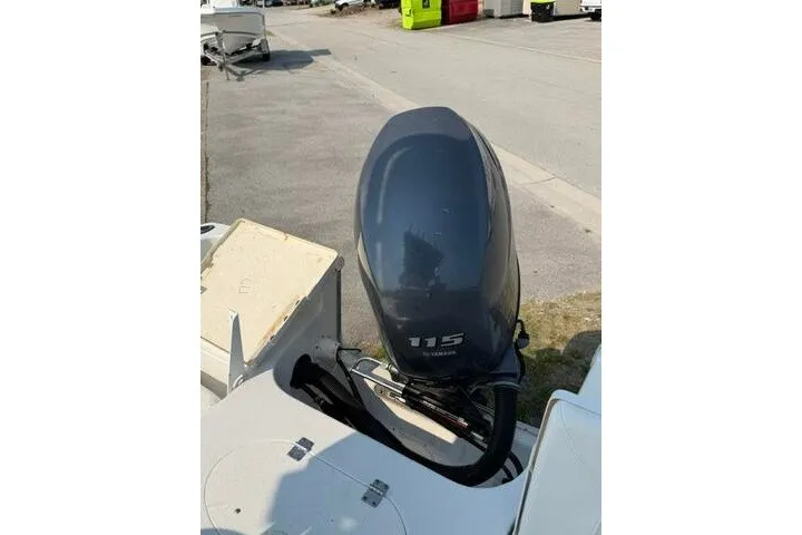 Slide: The Image of 2012 Sea Hunt Triton 177 with Yamaha 115 outboard motor in a parking area. - 22