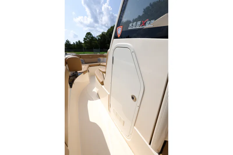 Slide: The Image of 2019 Scout 235 XSF boat interior with seating and storage compartment. - 14