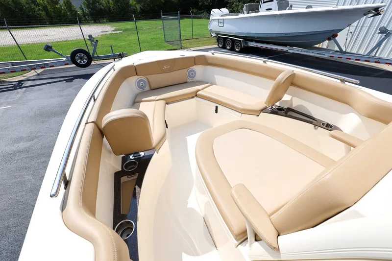 Slide: The Image of 2019 Scout 235 XSF boat interior with tan seating and cup holders. - 15