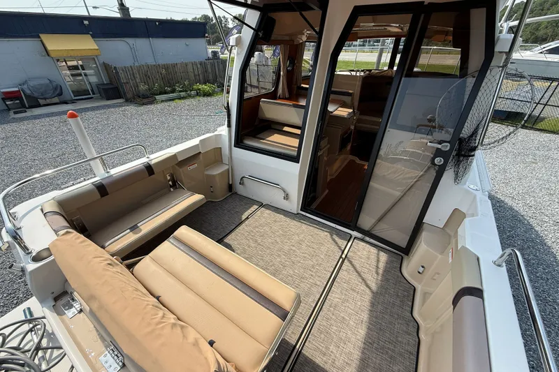 Slide: The Image of 2019 Ranger Tugs R-23 boat interior with seating and open cabin door. - 18