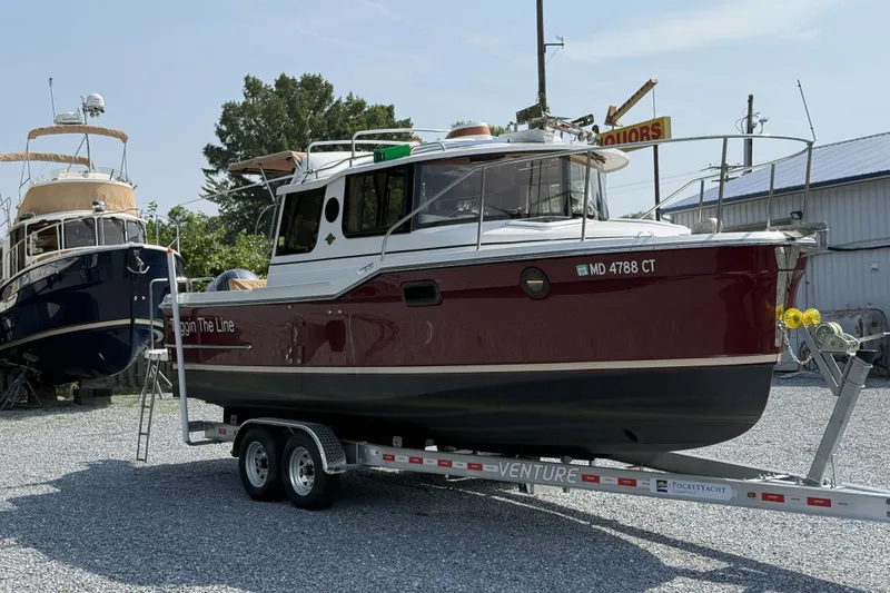 The Image of 2019 Ranger Tugs R-23 boat on trailer in outdoor storage area. - 1
