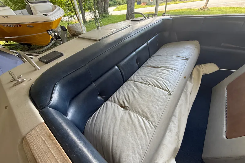 Slide: The Image of 1984 Century Coronado boat interior with blue and white seating, showcasing vintage design. - 14