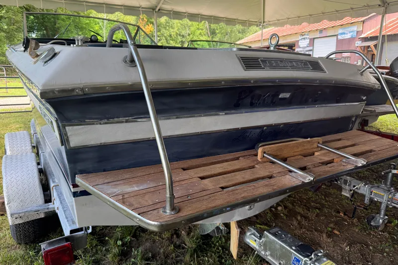Slide: The Image of 1984 Century Coronado boat on trailer with wooden swim platform under a canopy. - 16