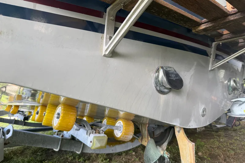 Slide: The Image of 1984 Century Coronado boat on trailer with yellow rollers, showing hull details. - 15