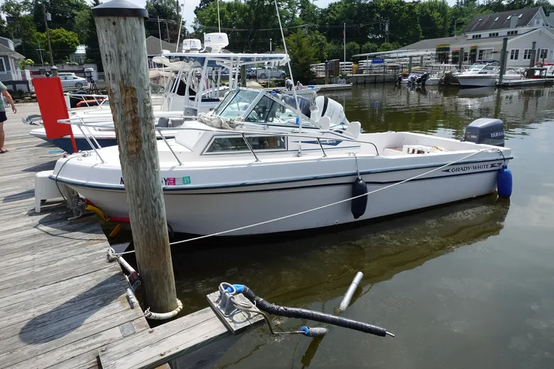 Slide: The Image of 1987 Grady-White Overnighter 206 boat docked at a marina with Yamaha outboard motor. - 4