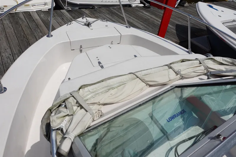 Slide: The Image of 1987 Grady-White Overnighter 206 boat deck with folded canopy and railing. - 3
