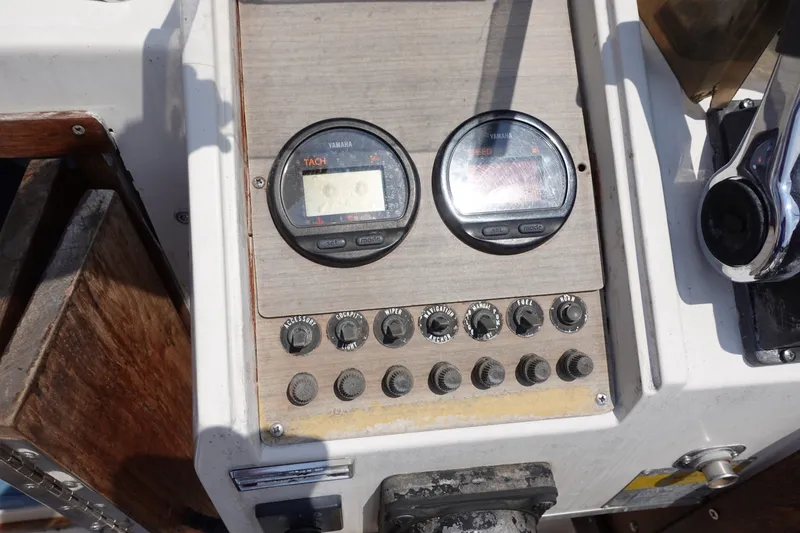 Slide: The Image of Control panel of a 1987 Grady-White Overnighter 206 boat with gauges and switches. - 8