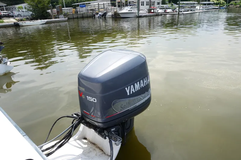 Slide: The Image of 1987 Grady-White Overnighter 206 with Yamaha V6 150 outboard motor on calm water. - 13